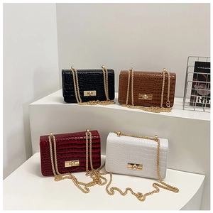 Detail view of stylish stone-patterned crossbody bags in four colors with gold metal chains