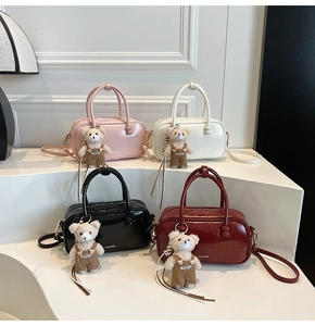 Detail of multi-color minimalist crossbody handbags with adorable teddy bear charms