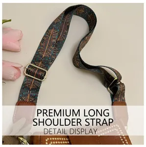 Detail of bohemian jacquard strap on brown crossbody bucket bag with golden hardware