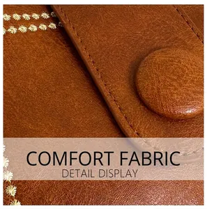 Macro view of brown lychee leather texture with floral embroidery and fine stitching