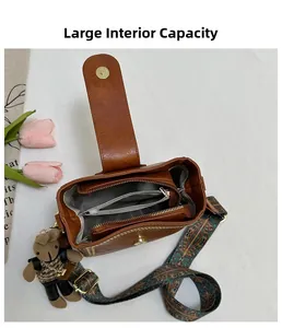 Detail view of brown retro bucket bag with large capacity interior and bear charm