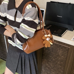 Retro brown oil wax leather underarm bag with cute plush bear charm for daily commute