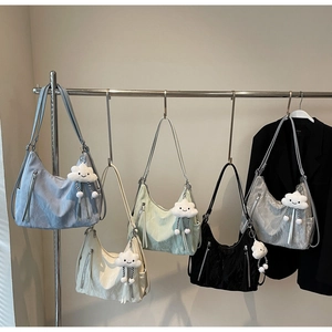 Nylon crescent handbags in five colors with cute cloud pendants on a display rack
