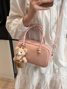 Pink PU leather small Boston bag with teddy bear charm shown in a mirror selfie