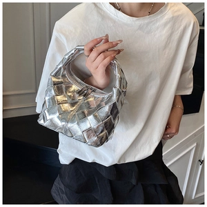 Sac hobo tissé argenté avec texture tressée classique porté par un mannequin en intérieur