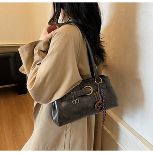 Detail view of deep coffee vintage leather shoulder bag with golden ring buckle decoration