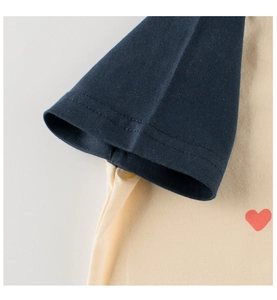 Detail of raglan sleeves and red heart print on a breathable cotton kids t-shirt