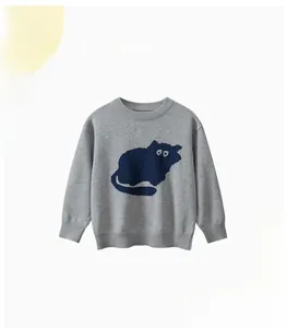 Detail of grey knitted kids sweater featuring a navy blue cat pattern and ribbed cuffs