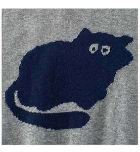 Detail shot of a grey knitted children sweater featuring a dark blue cat jacquard pattern