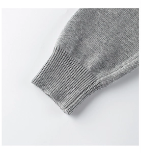 Macro shot of grey ribbed knit cuffs on a soft children sweater with detailed texture