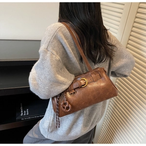 Brown vintage faux leather underarm bag shown on a model for everyday style and size