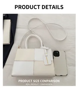 Top view of patchwork crossbody bag with handle, showing size relative to a smartphone