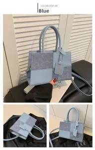 Detail view of light blue crossbody bag with four-grid patchwork and twin top handles