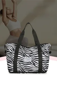 Close-up of zebra pattern travel bag featuring waterproof fabric and bottom expansion layer