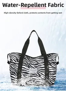 Close-up showing the water-repellent properties of the zebra print oxford fabric bag