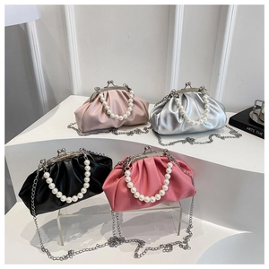 Detailed view of four pleated cloud bags in pink, silver, black, and magenta with pearl handles
