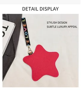 Detail of star-shaped rose red coin purse with textured leather and rainbow strap