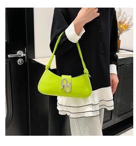 Close-up of lime green baguette bag with silver RH logo buckle and knotted shoulder strap