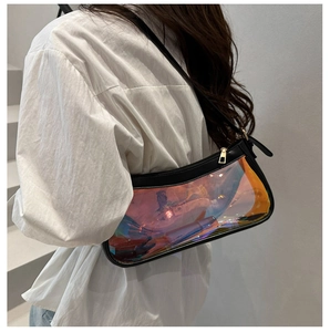 Iridescent transparent shoulder bag with black trim shown on model against white background