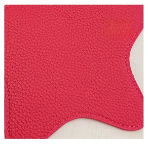 Detailed macro view of rose pink lychee grain leather and precise double stitching