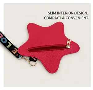 Close-up of a red star-shaped coin purse with gold zipper and woven letter strap