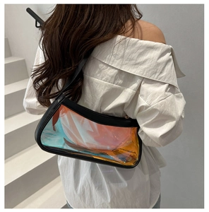 Detail view of the holographic PVC material and black leather trim on this stylish bag