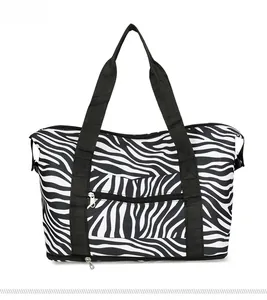 Rear view of large zebra pattern travel bag with dual handles and zipper compartments