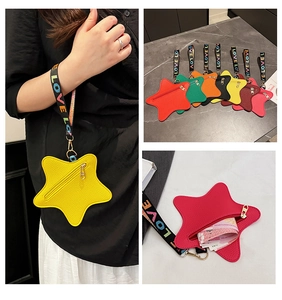 Detail of star-shaped coin purses in multi-colors with LOVE rainbow wrist straps