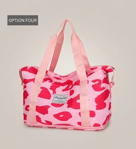 Detailed view of pink camouflage travel bag with water-resistant fabric and woven label
