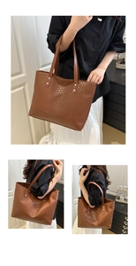 Detail of brown woven tote bag showing silver rivets and leather handles for women