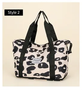 Detail of travel tote bag featuring leopard print fabric and durable woven handles