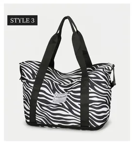 Detail of waterproof zebra print oxford fabric travel bag with reinforced stitching handles