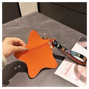 Detail of orange star-shaped pouch with lychee leather and colorful LOVE strap