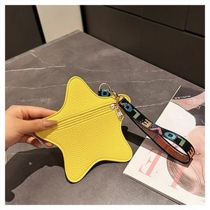 Detail of yellow star coin purse with litchi grain texture and LOVE strap on stone surface
