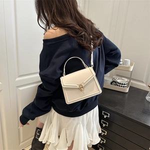 Minimalist cream white crossbody square bag with V-shaped stitching and gold oval buckle