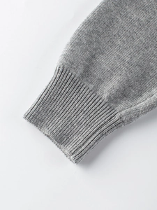 Classic grey rib-knit cuff detail on a children's knit sweater with fine texture