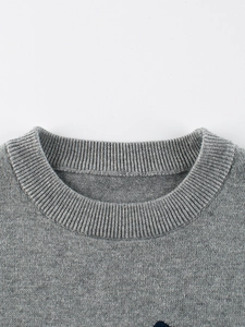 Gray knitted sweater for girls featuring a ribbed crew neck and high-quality fabric texture