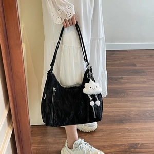 Fashionable black pleated shoulder bag with silver zipper and white cloud plush charm