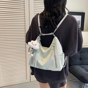 Light green faux leather backpack for women featuring cute white cloud charm and dual zippers