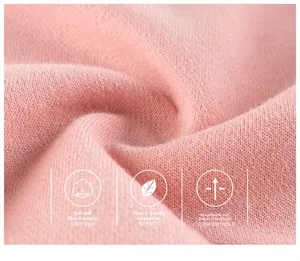 Close-up of soft pink breathable knitted fabric for children's pants with smooth texture