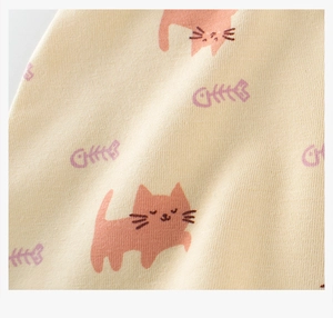 Macro shot of soft knit cotton fabric featuring cute kitten and fish bone patterns