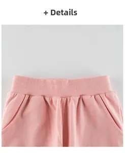 Detail of pink cotton casual shorts featuring an elastic waistband and side pockets
