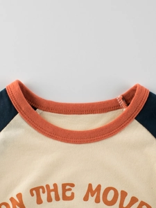 Kids cotton raglan short sleeve T-shirt featuring On The Move orange graphic print