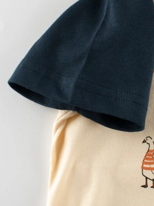 Kids short sleeve t-shirt with navy sleeves, cream body and cartoon goose print