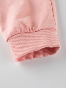 Pink girl's knitted joggers featuring high-quality ribbed cuffs and soft cotton fabric