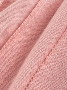 Detailed close-up of pink cotton fabric texture and precise stitching on girl sport pants
