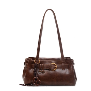Retro dark brown faux leather shoulder bag with decorative straps and pretzel pendant