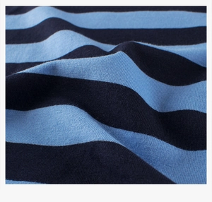 Macro shot of high-quality navy blue and light blue striped knitted cotton fabric texture