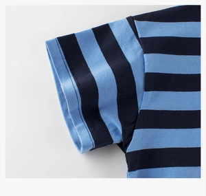 Detailed close-up of blue horizontal stripes and stitching on cotton t-shirt sleeve