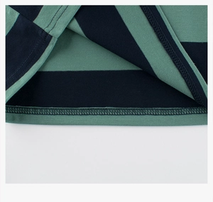 Detailed view of the double-needle hem and striped knit fabric on a boys' cotton tee